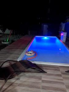 ein Schwimmbad in der Nacht mit Pizza darin in der Unterkunft Pousada Vista Verde in Paracuru