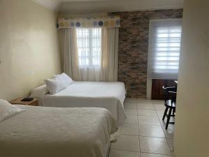 Кровать или кровати в номере Hotel Palermo Quintero