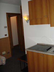 a kitchen with a sink and a counter top at Hotel Derby in Bormio