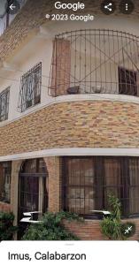 a brick building with a balcony on top of it at 4jMarte Home Stay in Imus