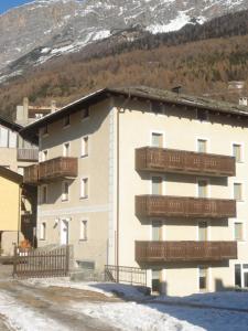 a large building with balconies on the side of it at Hotel Derby in Bormio