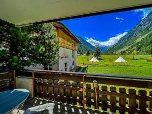 a balcony with a view of a field and mountains at Panorama apartment for 4 near Zermatt in Täsch