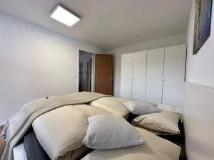 a bedroom with two beds with pillows on it at Panorama apartment for 4 near Zermatt in Täsch