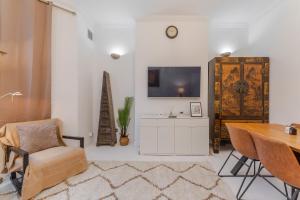 a living room with a tv and a table and chairs at property discarded in London