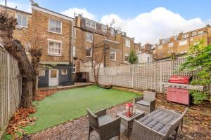 a backyard with a lawn in front of a building at property discarded in London