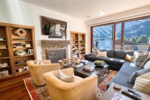 a living room with a couch and chairs and a fireplace at Luxe Ketchum Penthouse with Rooftop Hot Tub in Ketchum