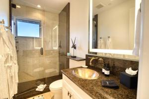 a bathroom with a sink and a toilet and a shower at Luxe Ketchum Penthouse with Rooftop Hot Tub in Ketchum