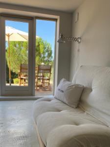a bed in a room with a view of a patio at NOUS in Agel +73 photos
