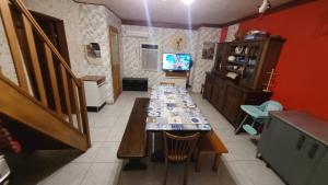 a living room with a table and a television at maison de vacances FRECONRUPT in La Broque