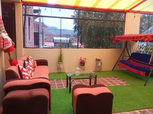 a screened in porch with two couches and a table at Sumac wasi in Chivay