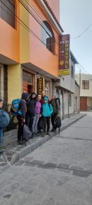a group of people standing outside of a building at Sumac wasi in Chivay