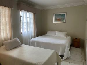 Кровать или кровати в номере Hotel Palermo Quintero
