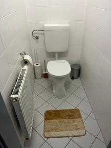 a small bathroom with a toilet and a rug at MM Luxury Apartments in Vienna