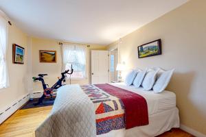 a bedroom with a large bed and a treadmill at Sugarwood Farmhouse in Wilmington