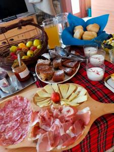 a table topped with lots of different types of food at Agritur Maso Flonkeri in Bosentino