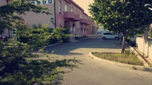 a car parked in a parking lot next to a building at Motel Aura in Mostar