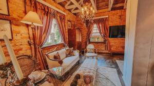 a living room with a couch and a table at Borgo 28 Gramado in Gramado
