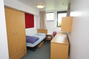 Ένα ή περισσότερα κρεβάτια σε δωμάτιο στο Perth Youth Hostel and Apartments