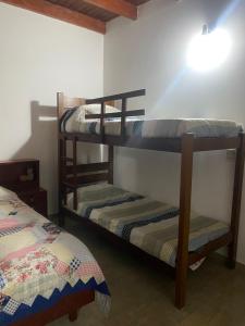 two bunk beds in a room with a bed at Casa Rural Doña Blanca in Samaipata