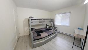 a bedroom with two bunk beds in a room at Oceanfront Villa in Ladysmith