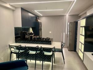 een eetkamer met een tafel en stoelen in een keuken bij Flat Luxo - Pé na Areia - Maui Beach Residence in Tamandaré