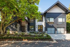 a white house with a tree in front of it at Bellevue Splendor Elm Room BY Betterstay in Bellevue