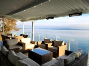 a living room with couches and a view of the ocean at Oceanfront Villa in Ladysmith