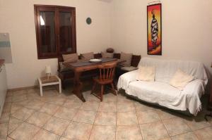 a living room with a couch and a table at Via Genova 1480 in San Teodoro