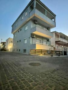 a large apartment building with a manhole in front of it at Afrodite II in Sarti
