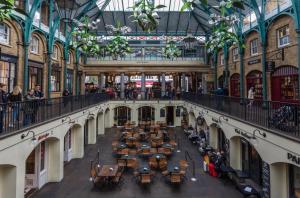 an overhead view of a shopping mall with tables and people at 3 Bedroom in the Heart of West End in London