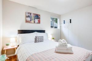 a white bedroom with a large bed and a window at Eastgate Rambler BY Betterstay in Bellevue