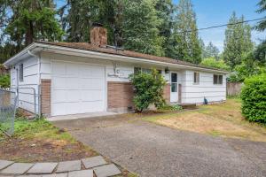 a white house with a garage at Eastgate Rambler BY Betterstay in Bellevue