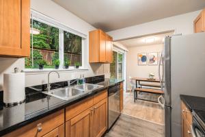 a kitchen with a sink and a refrigerator at Eastgate Rambler BY Betterstay in Bellevue