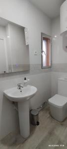 a white bathroom with a sink and a toilet at Apartamento Agradables 3 in Madrid