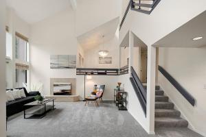 a living room with a couch and a staircase at Highland Haven BY Betterstay in Bellevue