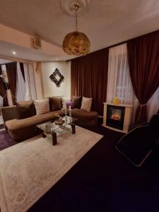 a living room with a couch and a fireplace at Apartmani Li in Livno