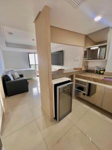 a large kitchen and living room with a counter top at MARINAS PRAIA Flat in João Pessoa