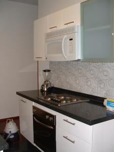 a kitchen with a stove and a microwave at AMAZING REFORMA APARTMENT, 2 brms 2 bath, AWESOME in Mexico City