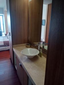 a bathroom with a white sink on a counter at AMAZING REFORMA APARTMENT, 2 brms 2 bath, AWESOME in Mexico City