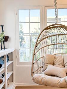 a rattan swing in a room with a window at Modern 2-Bedroom Gem Close to Beverly Hills - DOH2 in Los Angeles