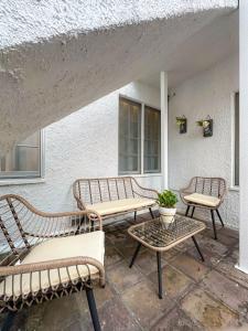 three benches and a table on a patio at Modern 2-Bedroom Gem Close to Beverly Hills - DOH2 in Los Angeles