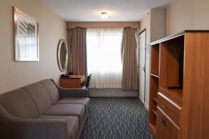 a living room with a couch and a large window at City Center Inn and Suites in San Francisco