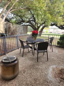 a table and chairs and a table with a pot and flowers at Casita #5 @ Riverhill in Kerrville