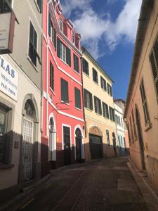 a red building on the side of a street at Moda Gibraltar - Central Location in Gibraltar