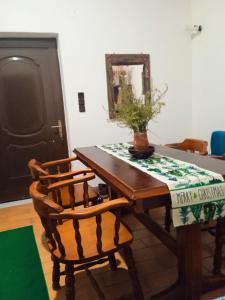 a dining room table with two chairs and a plant on it at Breakfast & Snacks, 2bedrooms 2bathrooms House in Kato Zachlorou