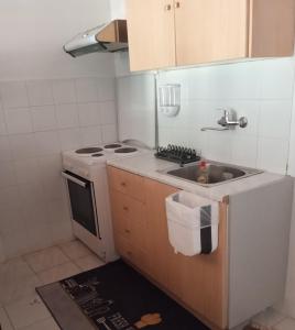 a small kitchen with a sink and a stove at Breakfast & Snacks, 2bedrooms 2bathrooms House in Kato Zachlorou