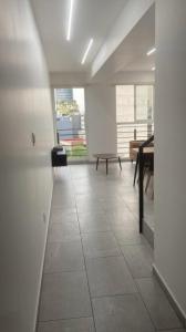 an empty room with a piano and a table at Departamento habitación privada balcón terraza in Mexico City