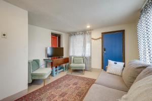 a living room with a couch and a desk and chairs at Pet-Friendly Home Near Downtown Albuquerque! in Albuquerque