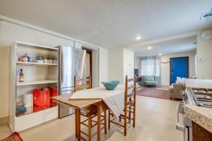 a kitchen with a table and a refrigerator at Pet-Friendly Home Near Downtown Albuquerque! in Albuquerque