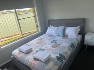 a bedroom with a bed with towels on it at 39onDewhurst in Mudgee